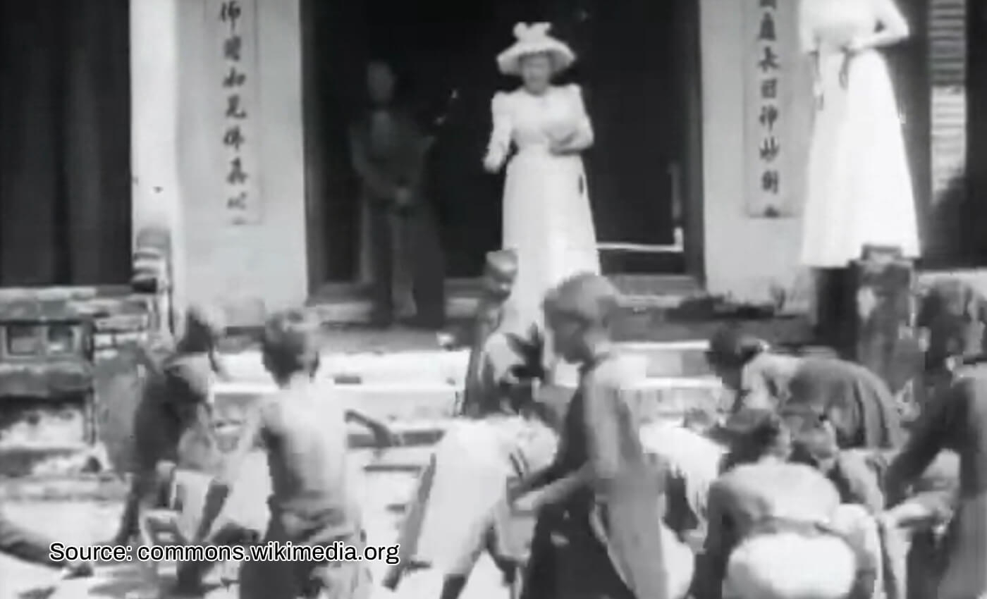 Queen Elizabeth II threw food at African children.