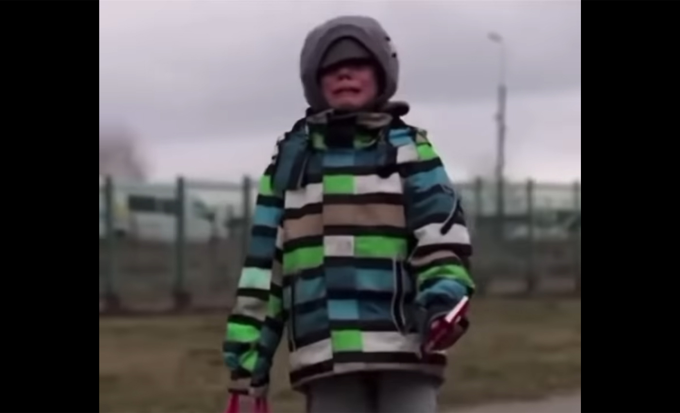 A video shows a small Ukrainian boy crying and walking to the border of Poland alone due to the Russian invasion.