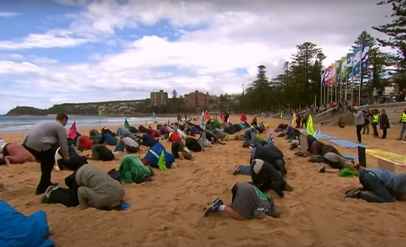A viral video of people burying their heads in the sand is from a protest organized by Greta Thunberg to reduce CO2 emissions.