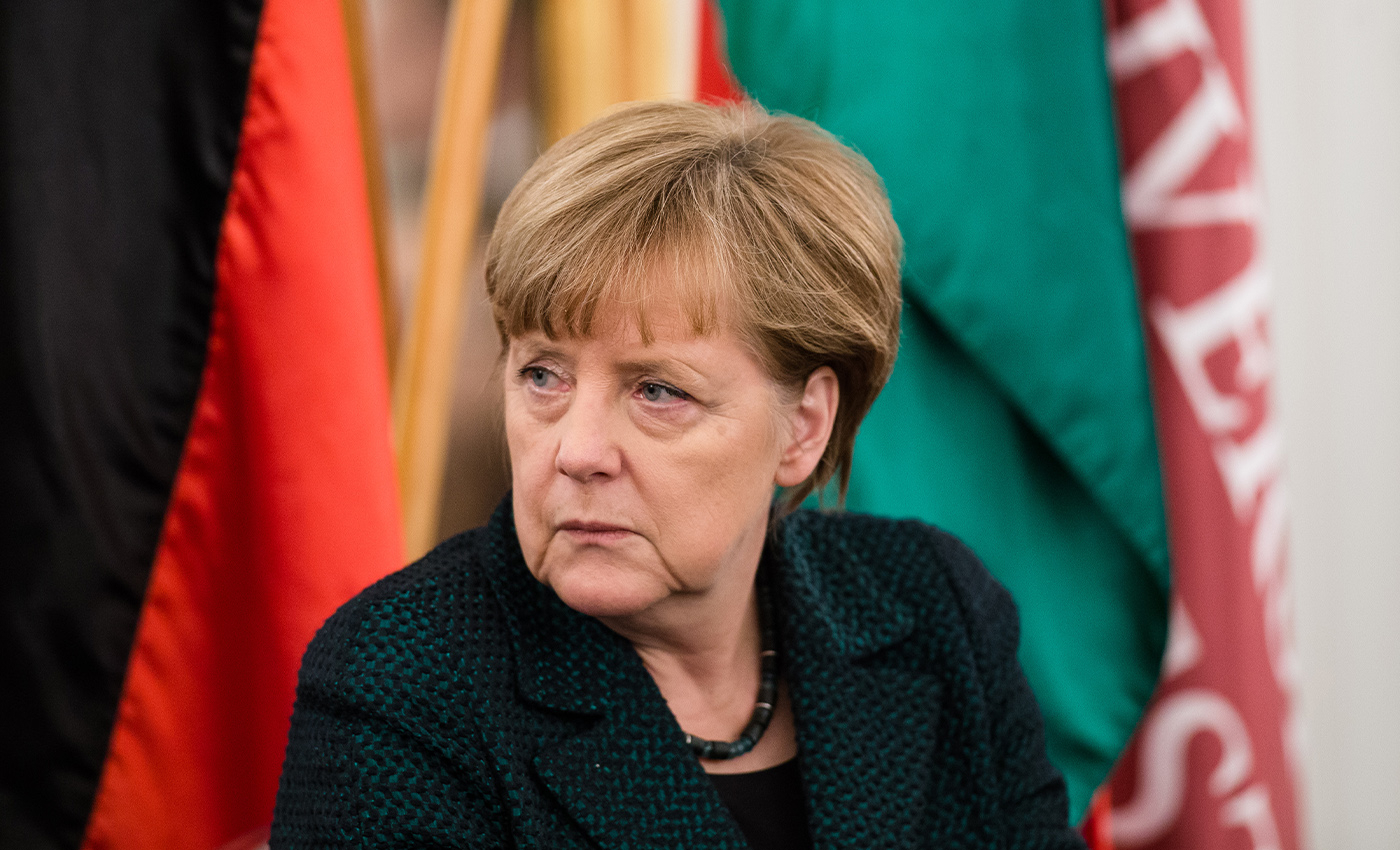 Angela Merkel panics as she forgets her mask during the parliament session.