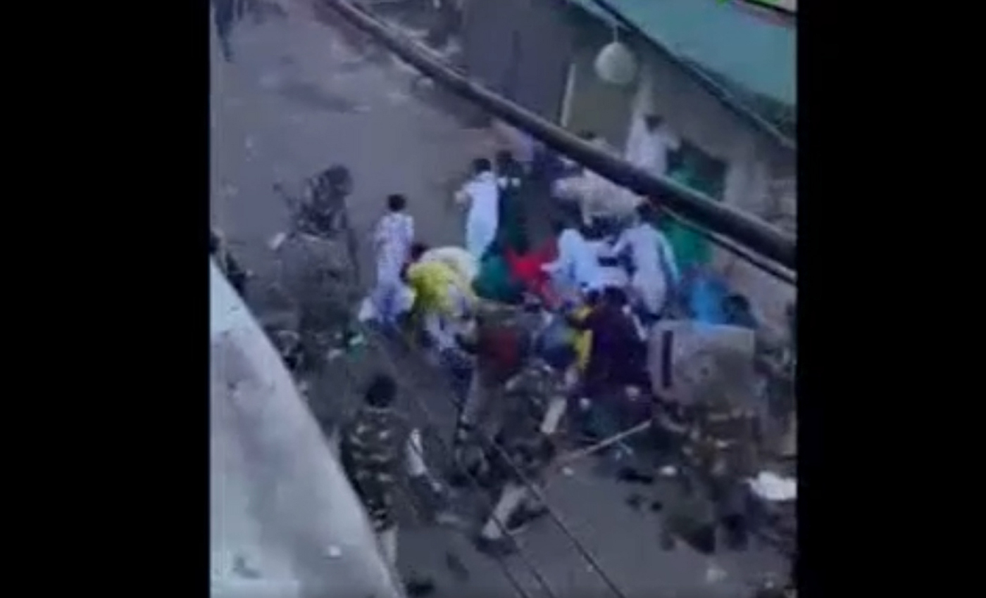The image from a video shows Uttar Pradesh police beating people offering prayers on the street.