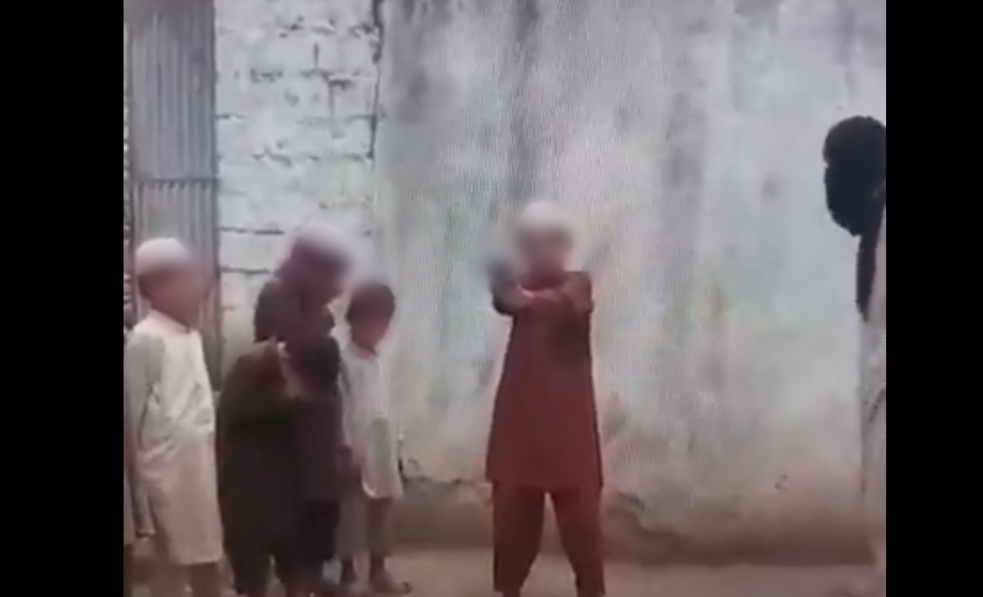 A video shows children being trained to shoot in a madrasa.