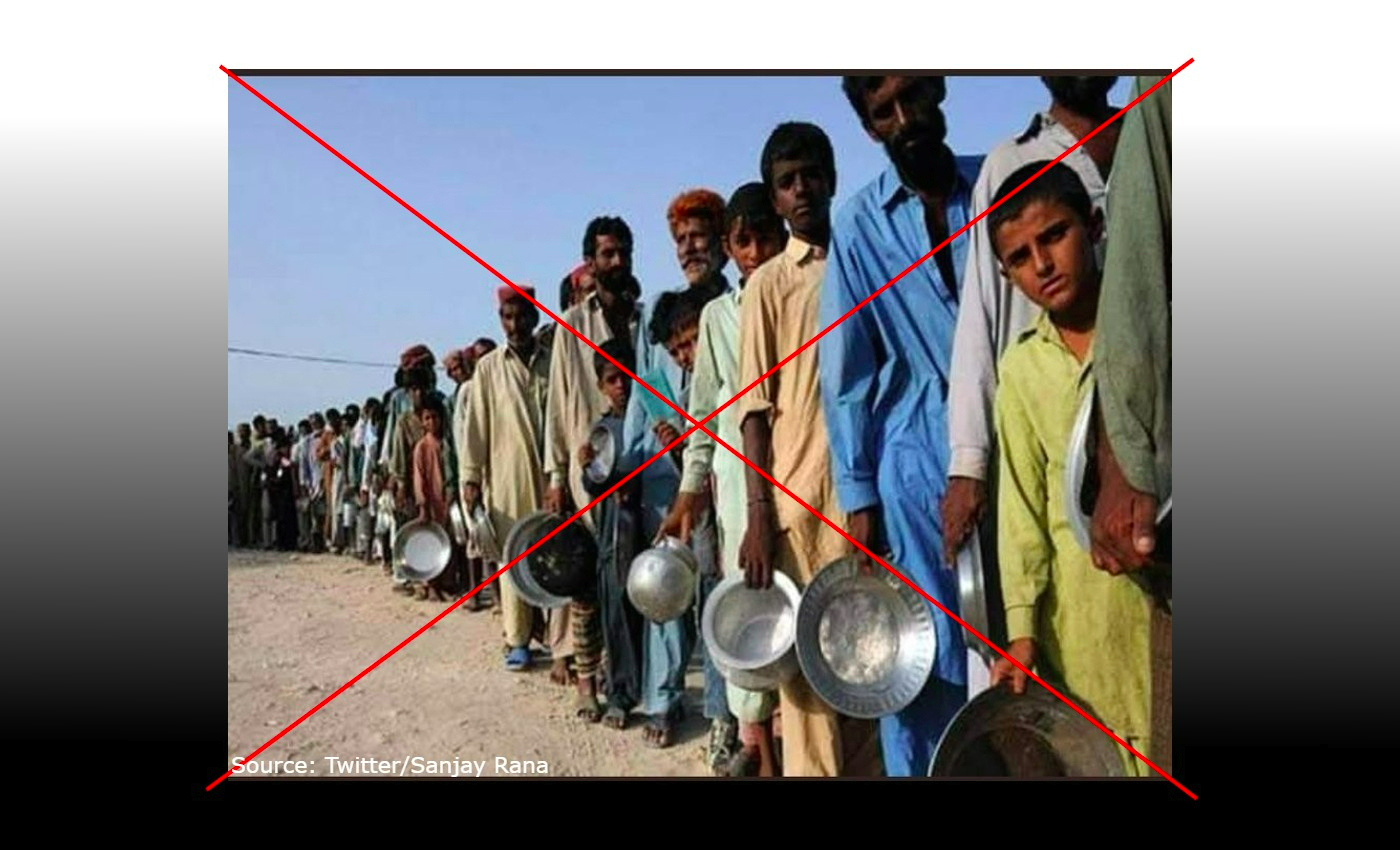 An image from the recent economic crisis in Pakistan shows people standing in line waiting for food.