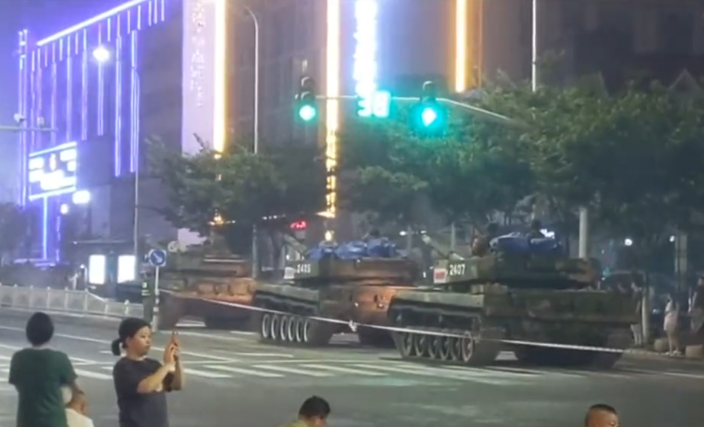 A video shows military tanks deployed in China's Henan province to protect banks from protesters.