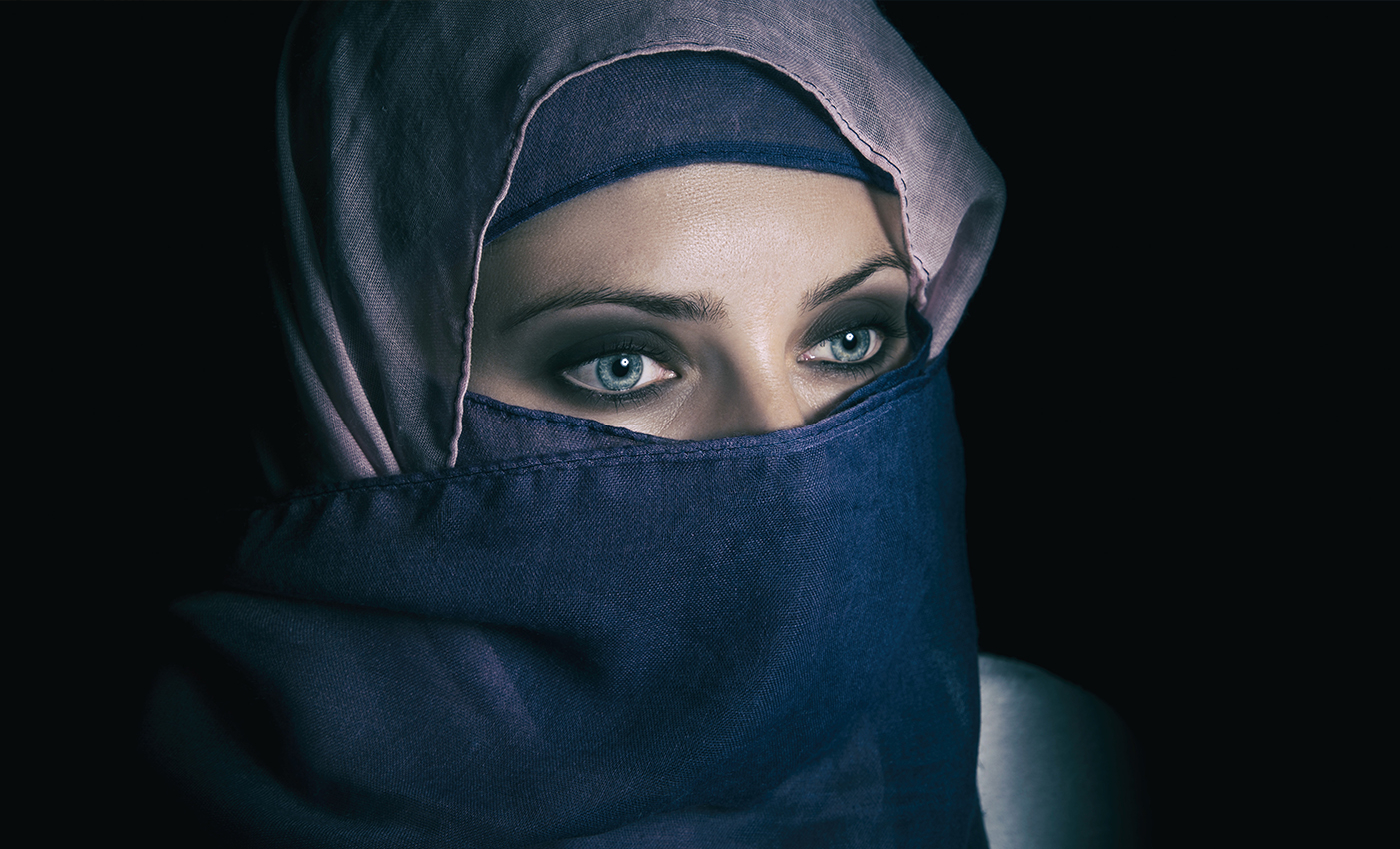 A man disguised as a woman in a burqa at a pro-Taliban women's gathering at Kabul University.