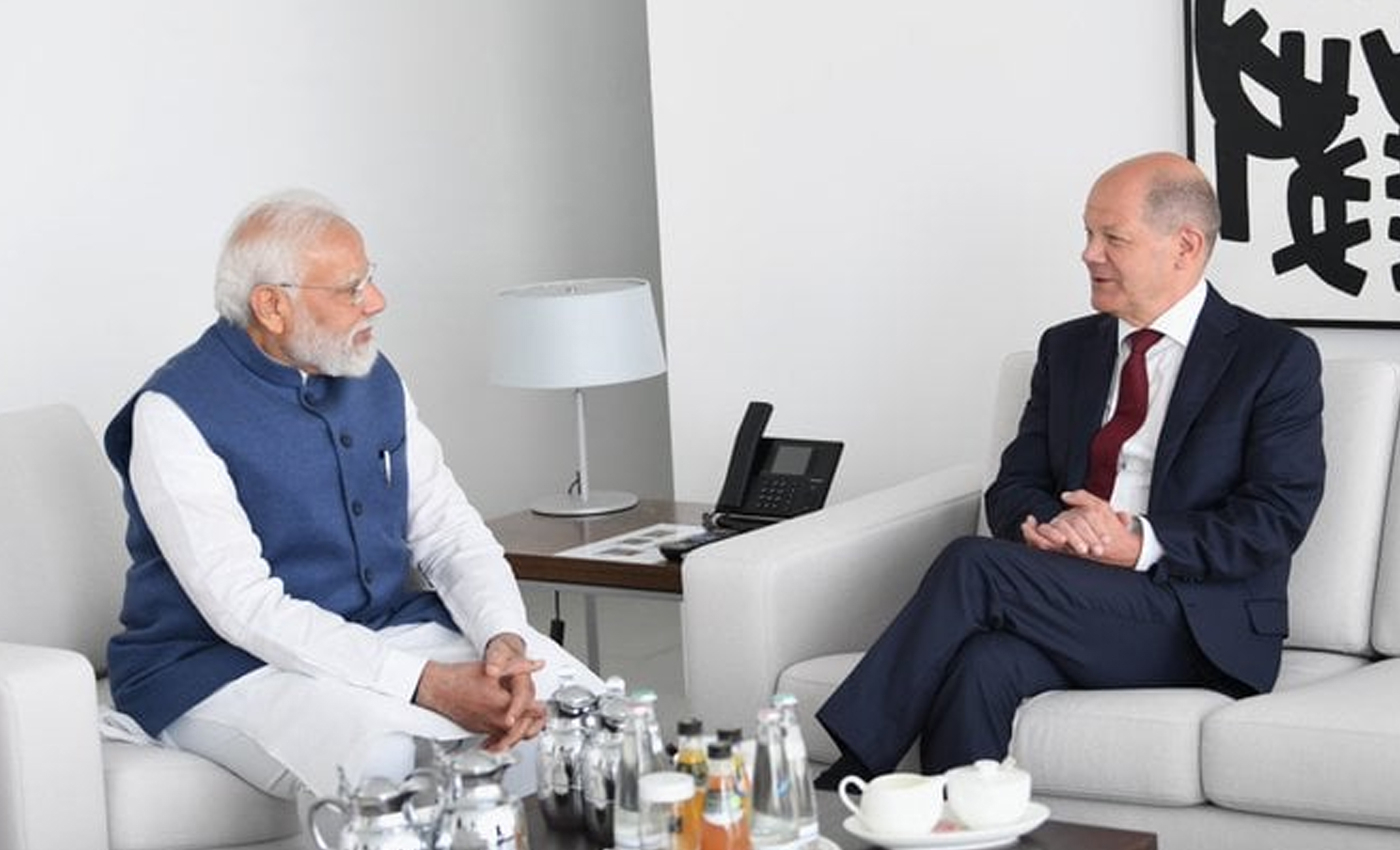 An image shows a portrait of Jawaharlal Nehru hanging on a wall at a meeting between Prime Minister Narendra Modi and German Chancellor Olaf Scholz.