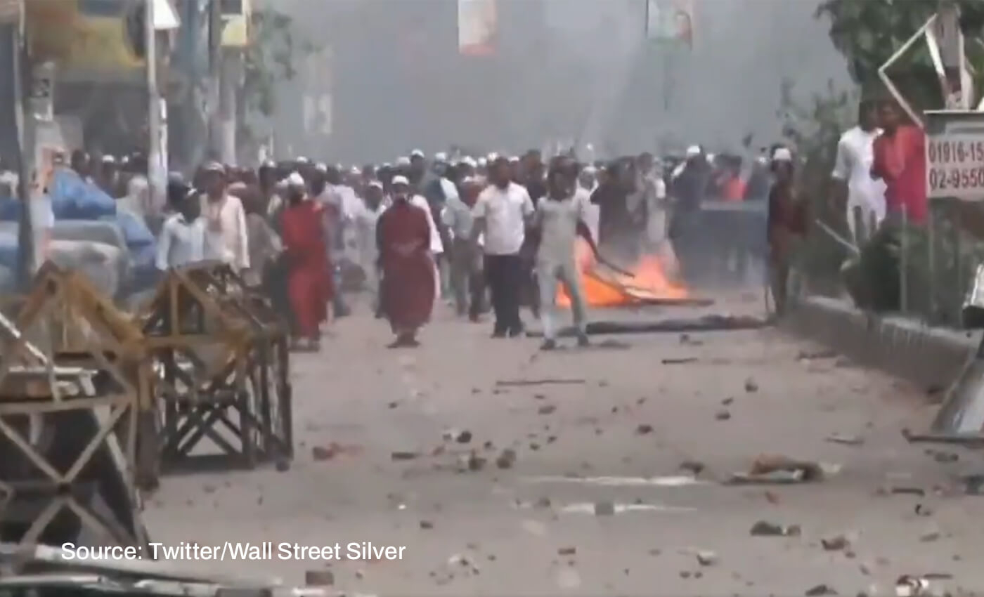 A video shows people pelting stones at police officials to protest fuel price hike in Bangladesh.