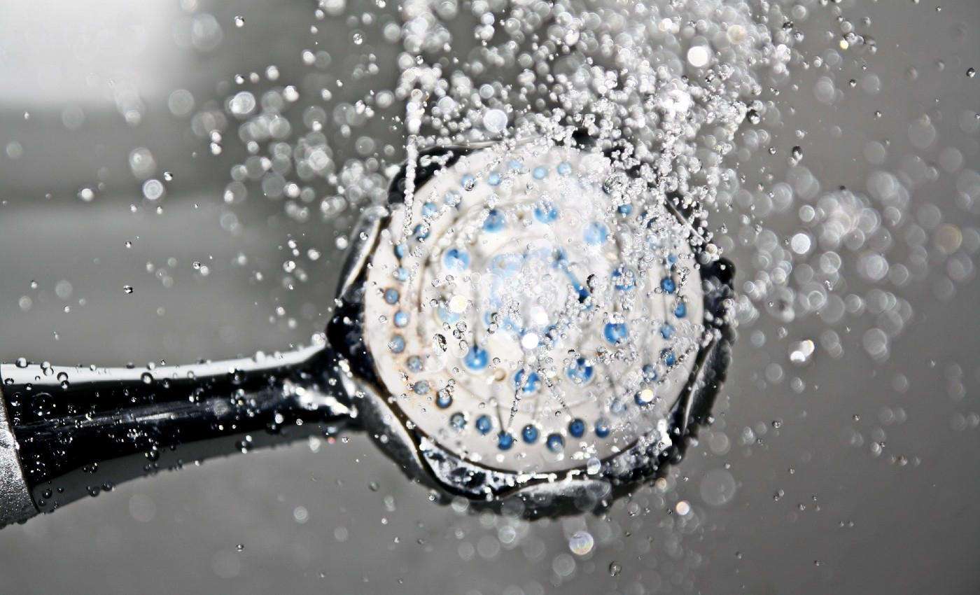 Showering in hot water can cure COVID-19.