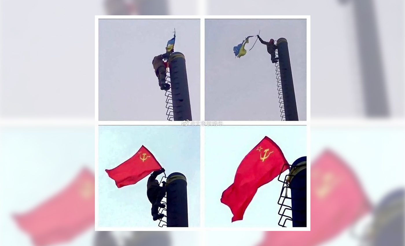 This image shows a Ukrainian flag being removed and a Soviet flag hoisted in its place in Mariupol during the 2022 Russian invasion.